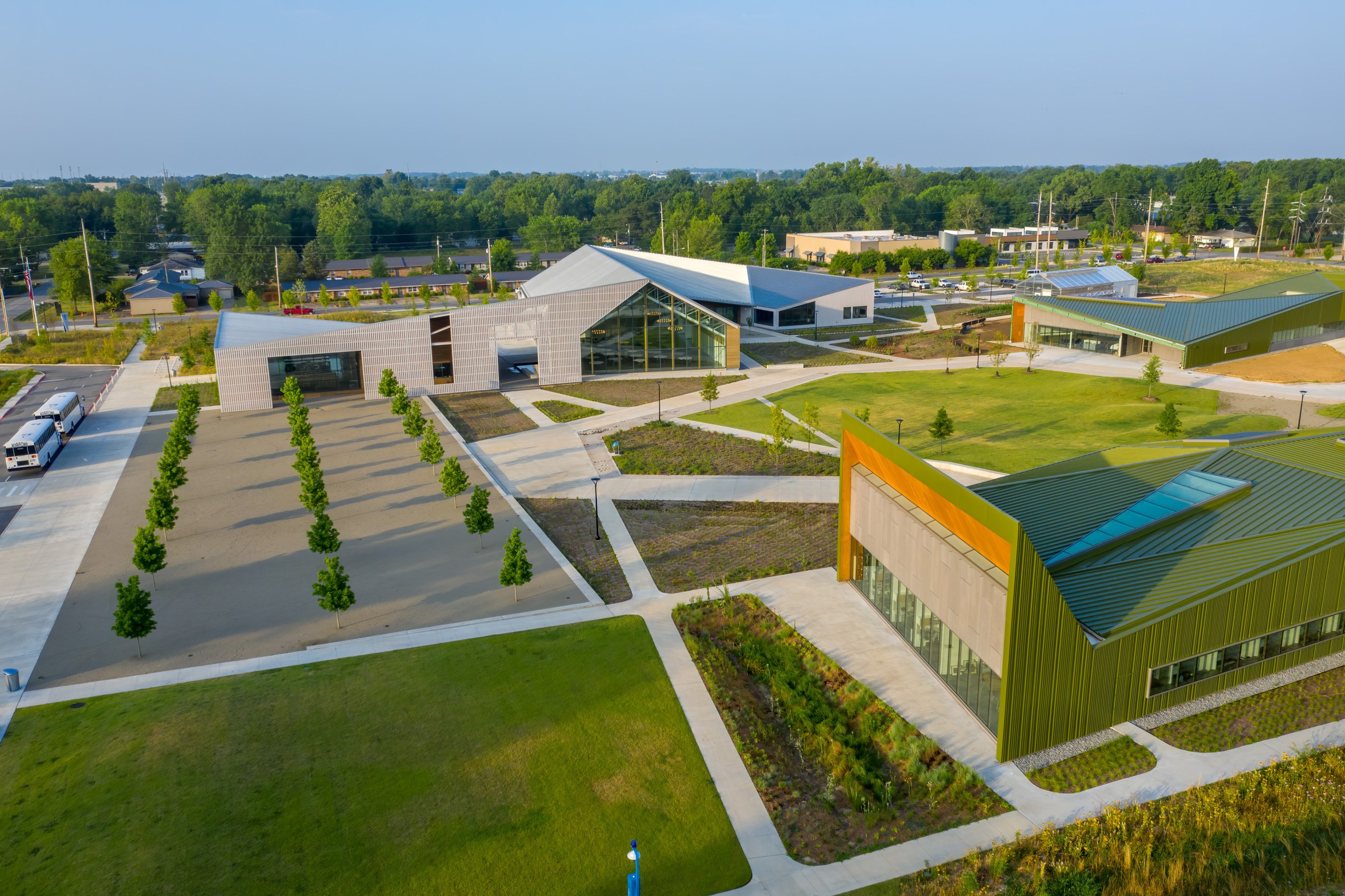 Aerial photo of a school campus with modern style buildings and large open outdoor, plaza spaces