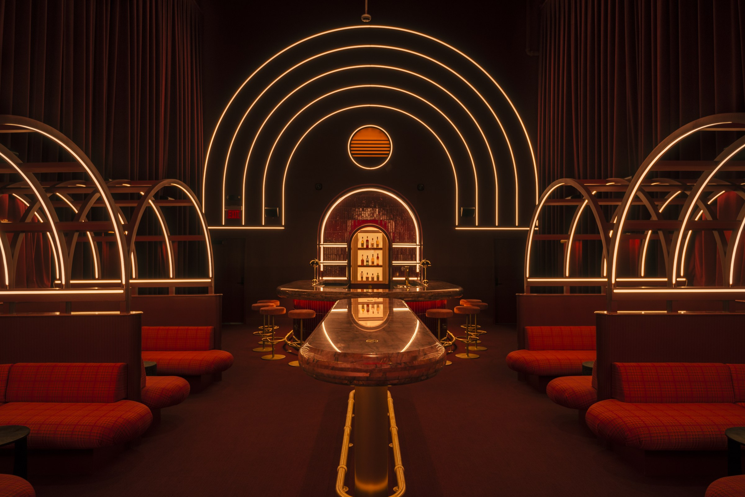 Interior of a dark bar with arched, art deco detailing 