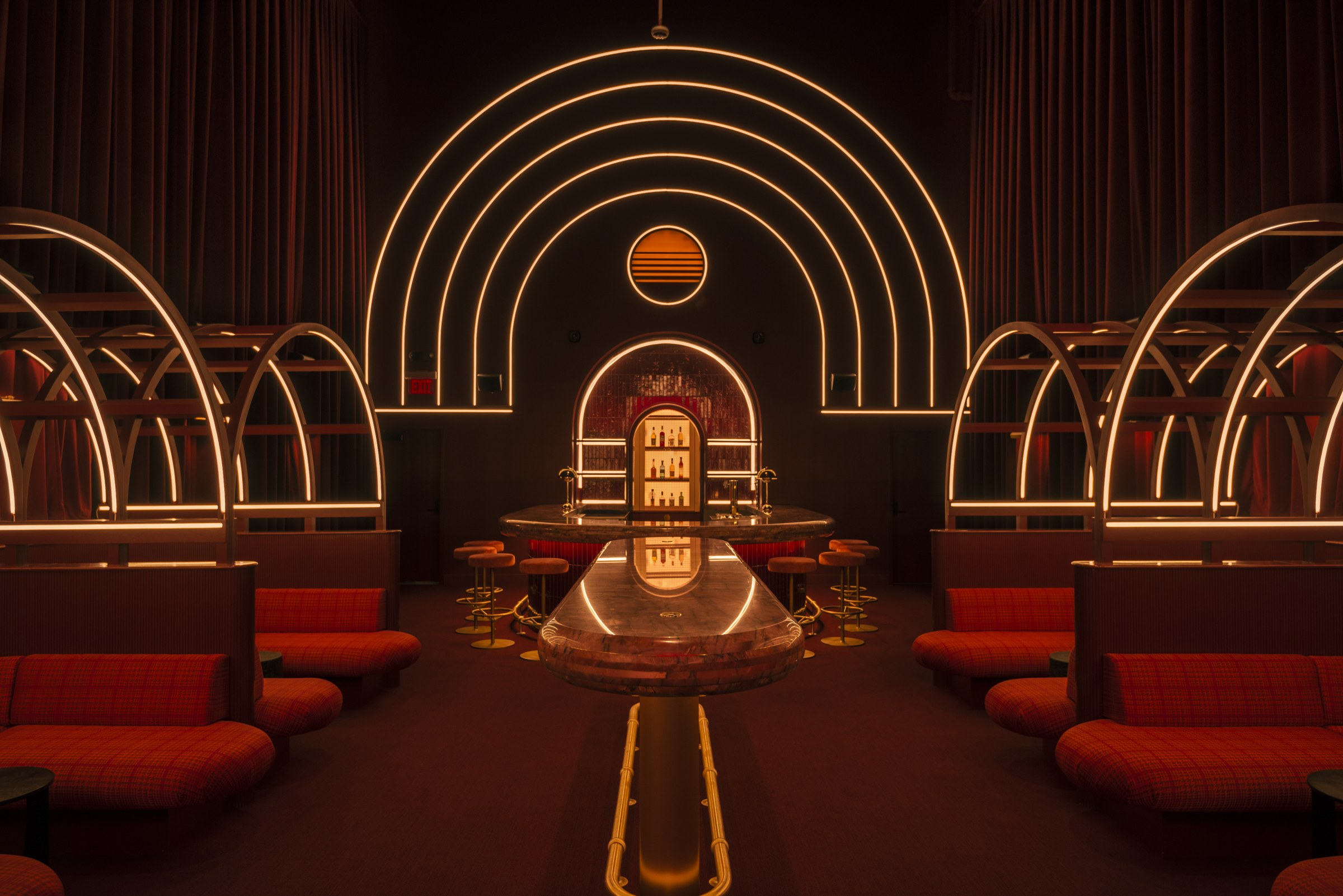 Interior of a dark bar with arched, art deco detailing