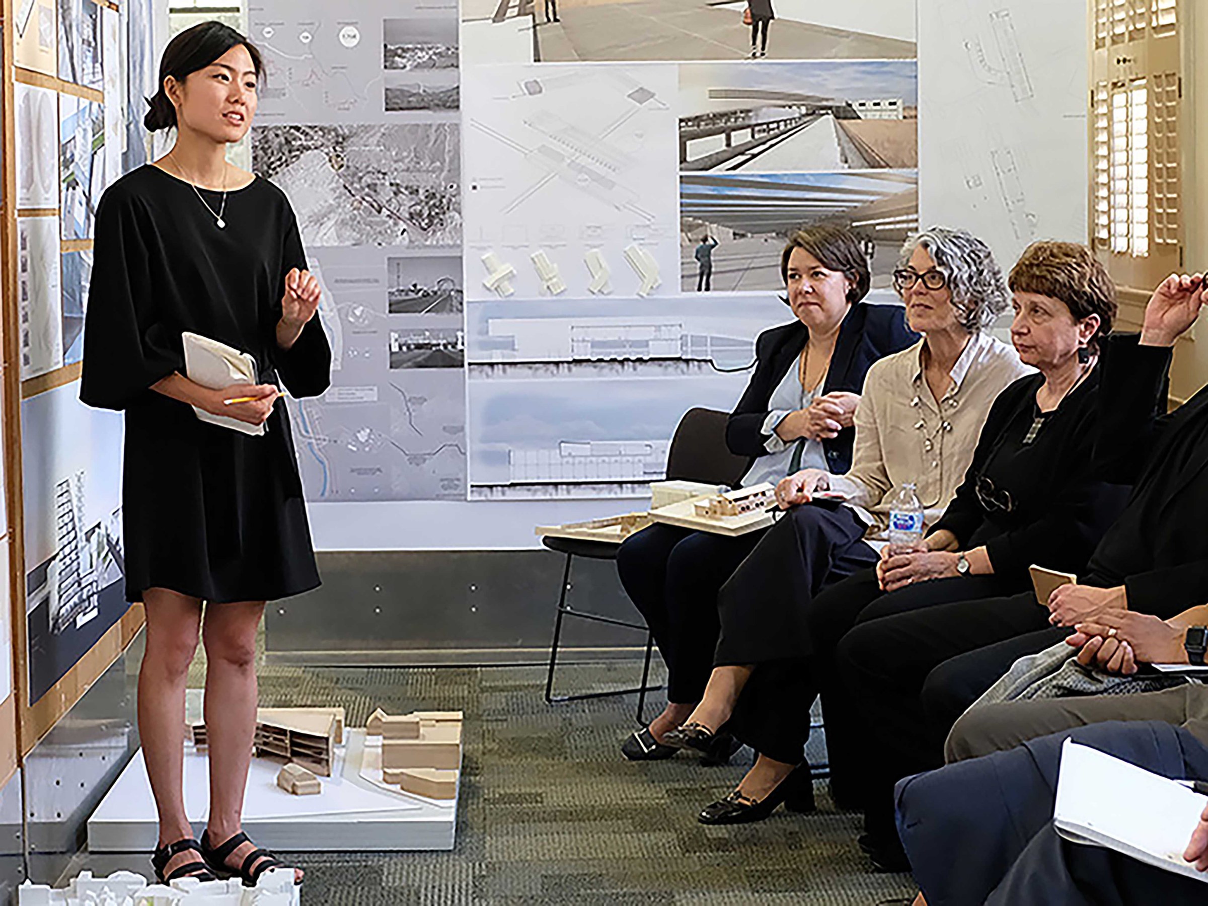 Photo of woman presenting proposal to audience