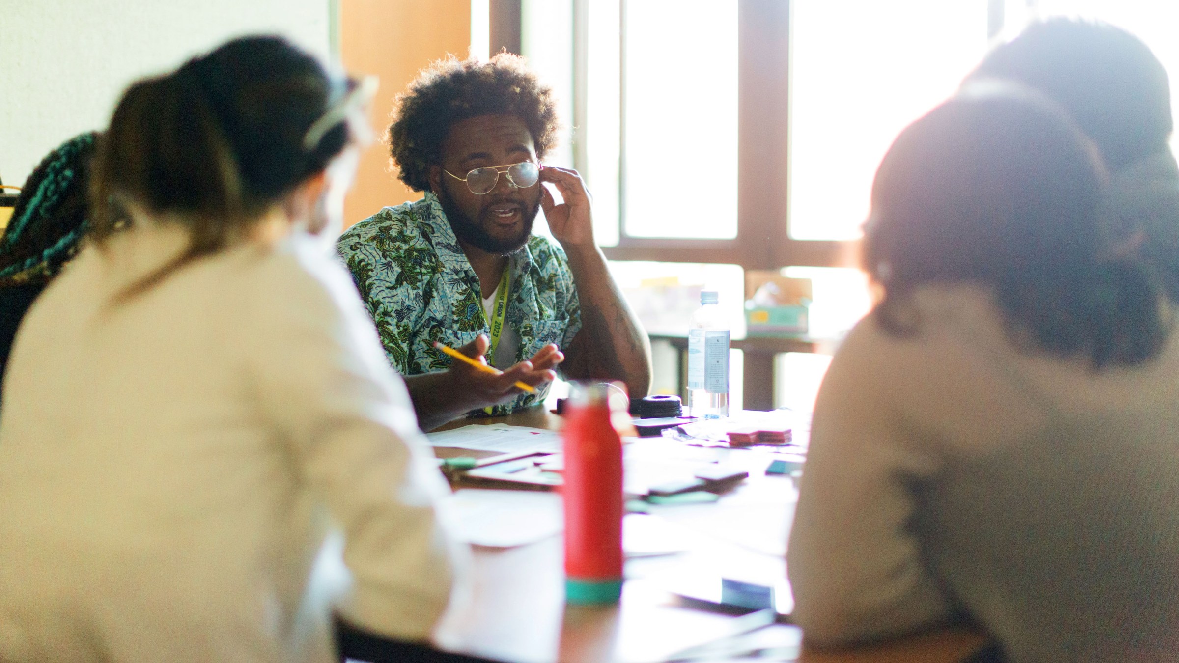 a group of students gathered at a table at the design futures forum