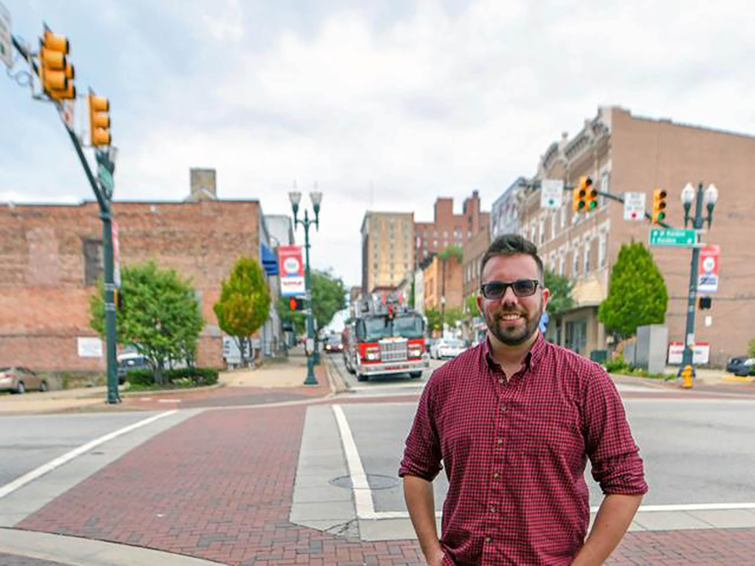 Photo of Will Prince in front of town intersection 