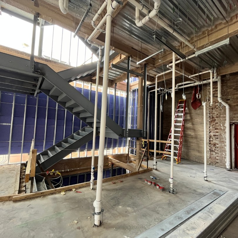 Interior view of renovation sheathing, stairs and plumbing at RMH second floor addition.