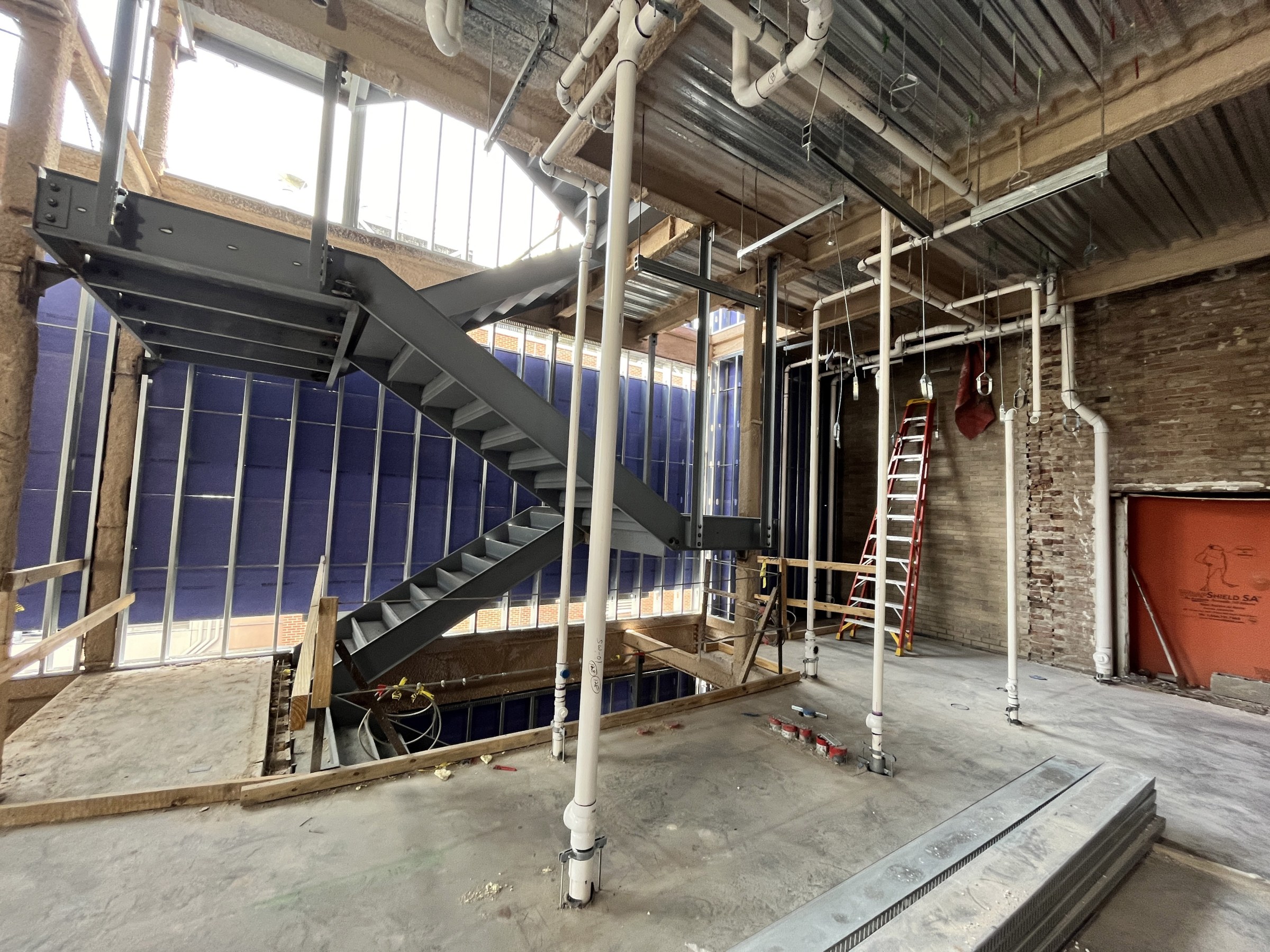 Interior view of renovation sheathing, stairs and plumbing at RMH second floor addition.