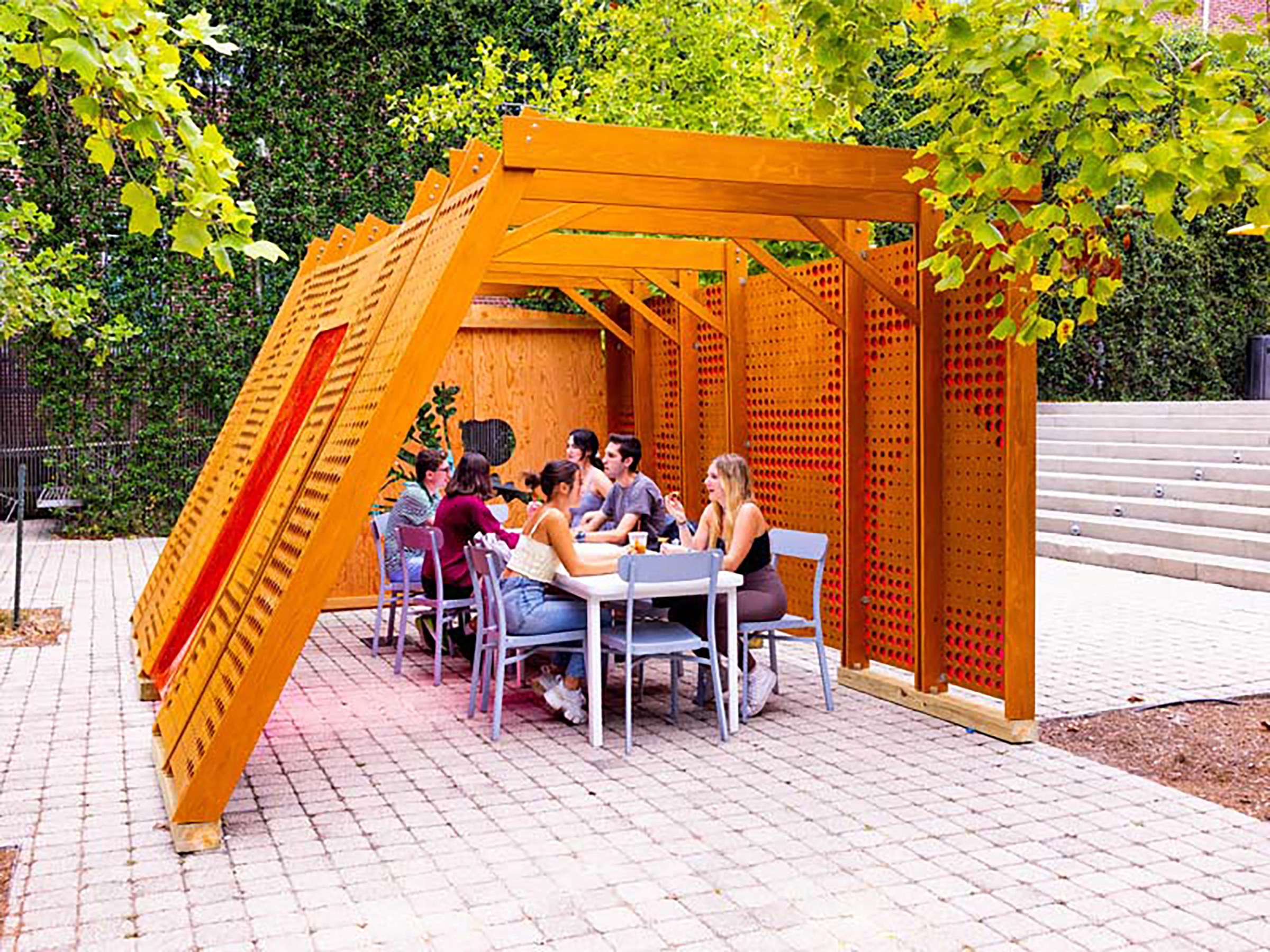 Students sitting in modern Sukkah 