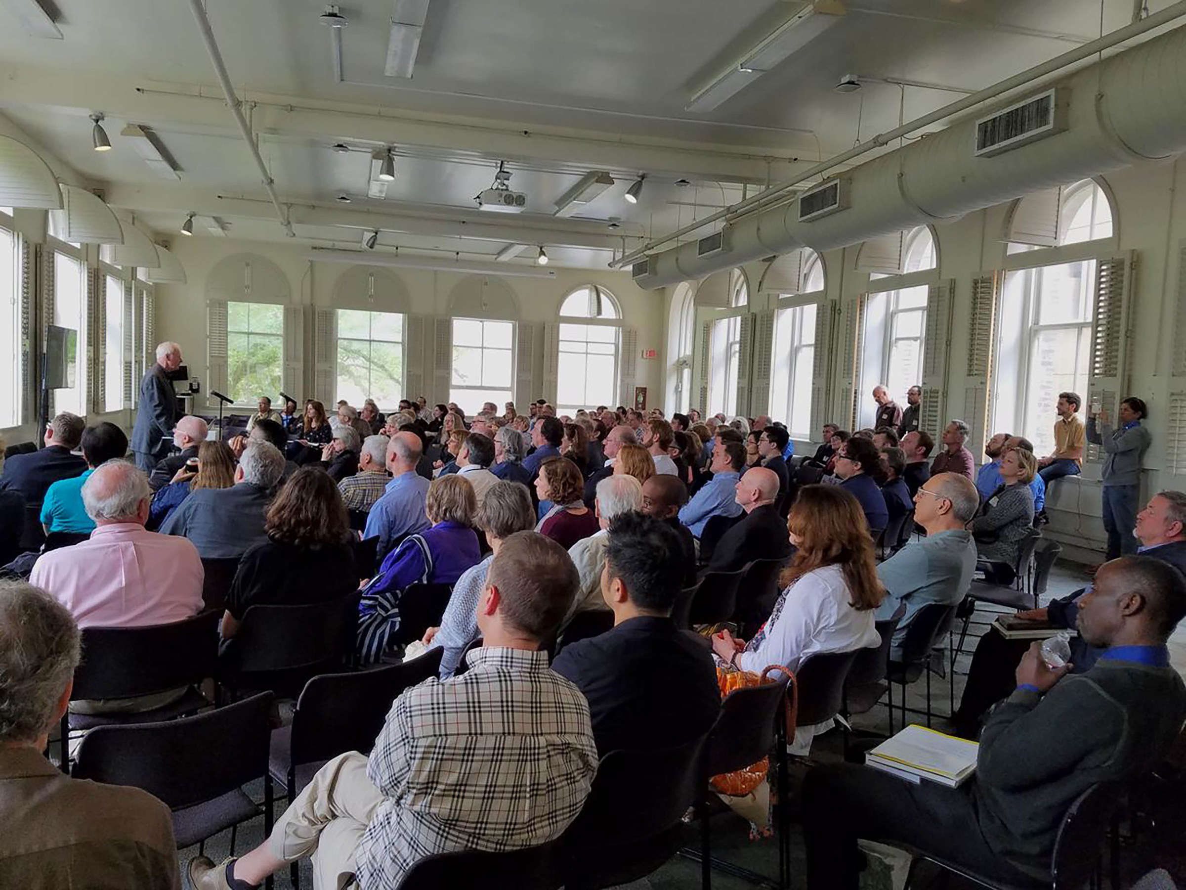 Audience watching lecture by professor in front of the room 