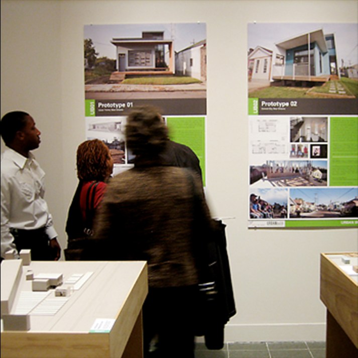 people gathering at posters of prototyped designs