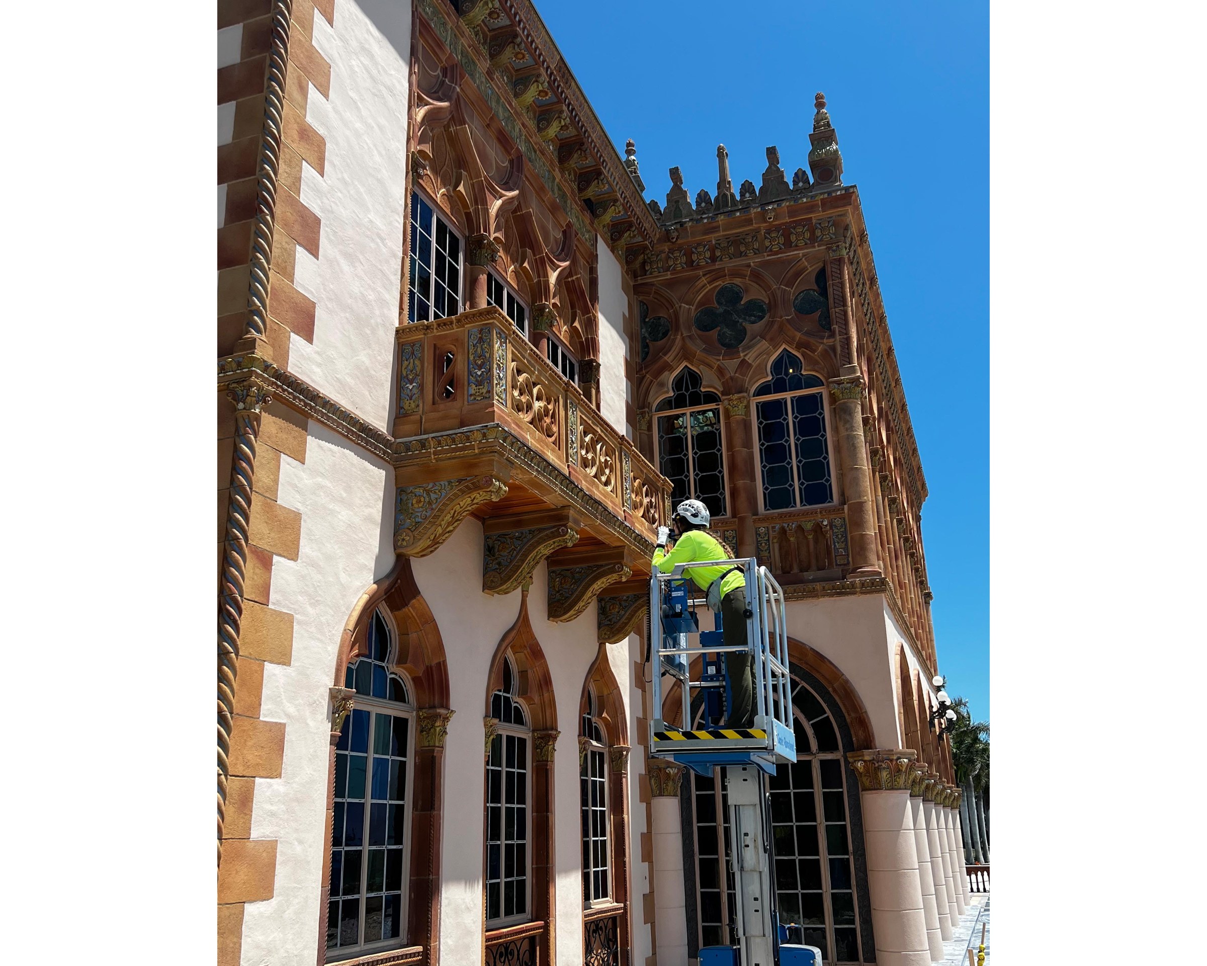 exterior image of Emma Kousouris working on a building