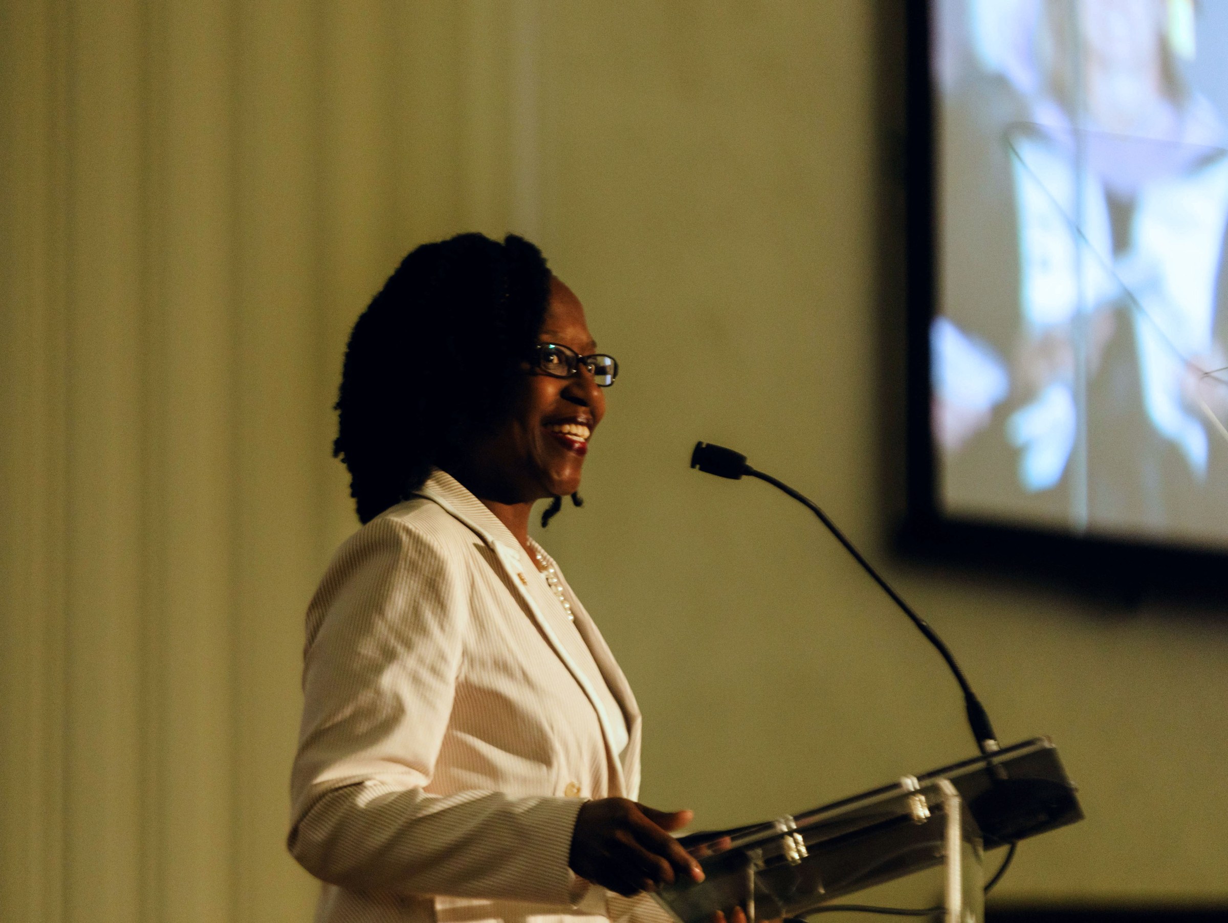 Close up of Nicole Hobson-Morris, alumni, giving a commencement speech at a podium.