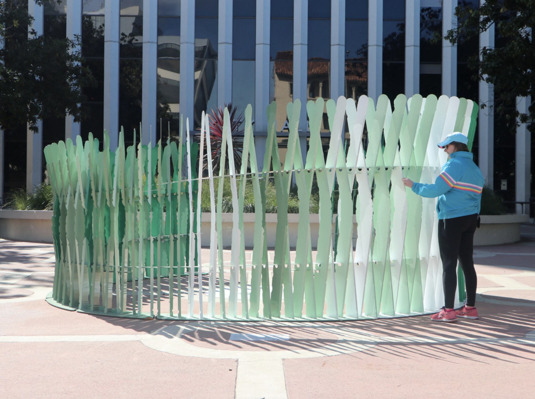 Picture of green sculpture with sharp ends in front of building