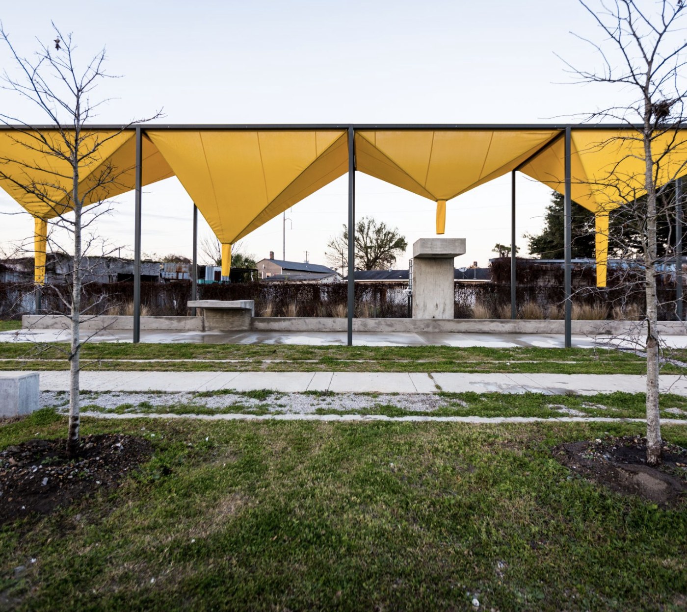 image of a yellow pavilion outside from a distance 