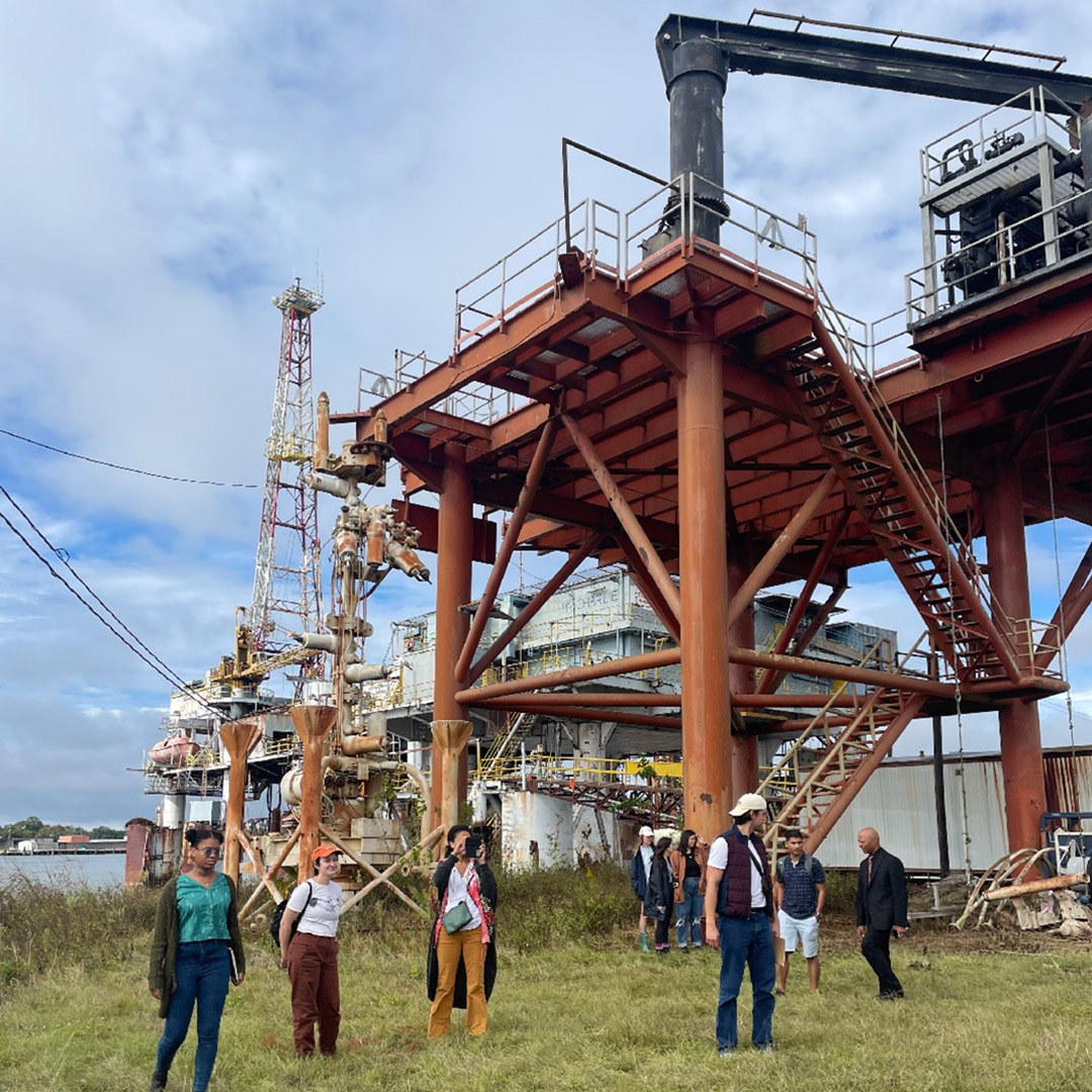 image of people working together in a field with large scaffold