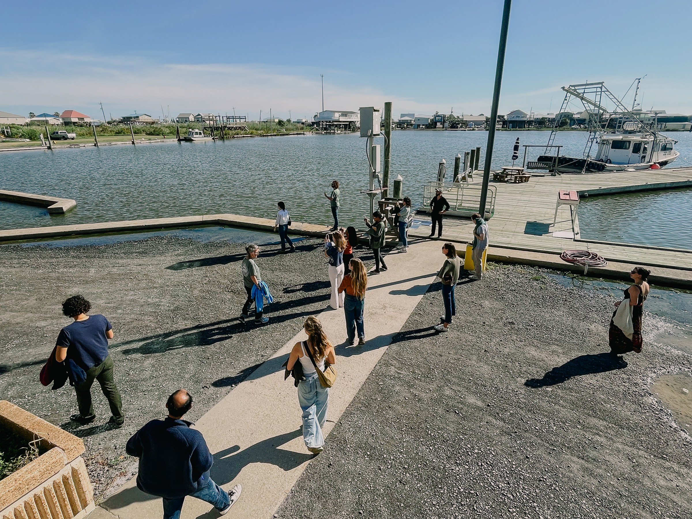 image of people walking around a dock, in professional outfits