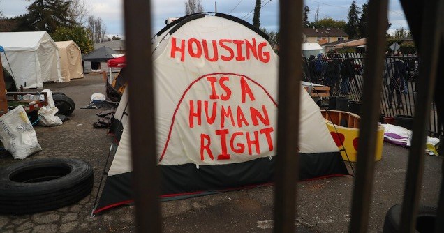 Tent with Housing is a Human Right written on it