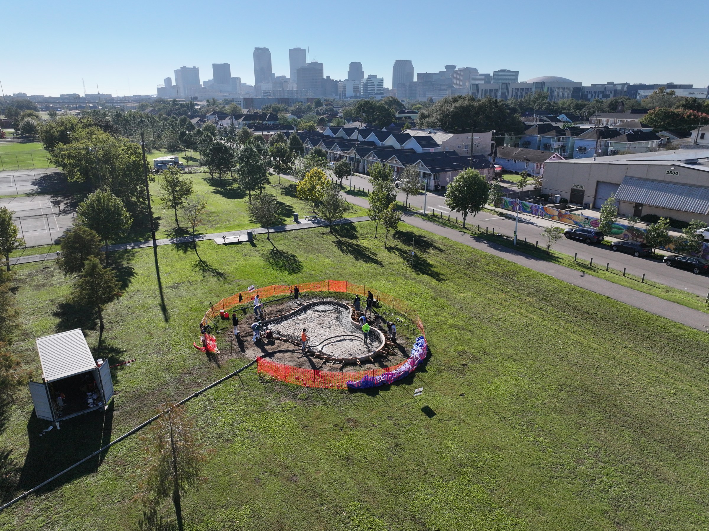 Drone aerial view of Sprout House site along the Lafitte Greenway with downtown New Orleans in the background/horizon.