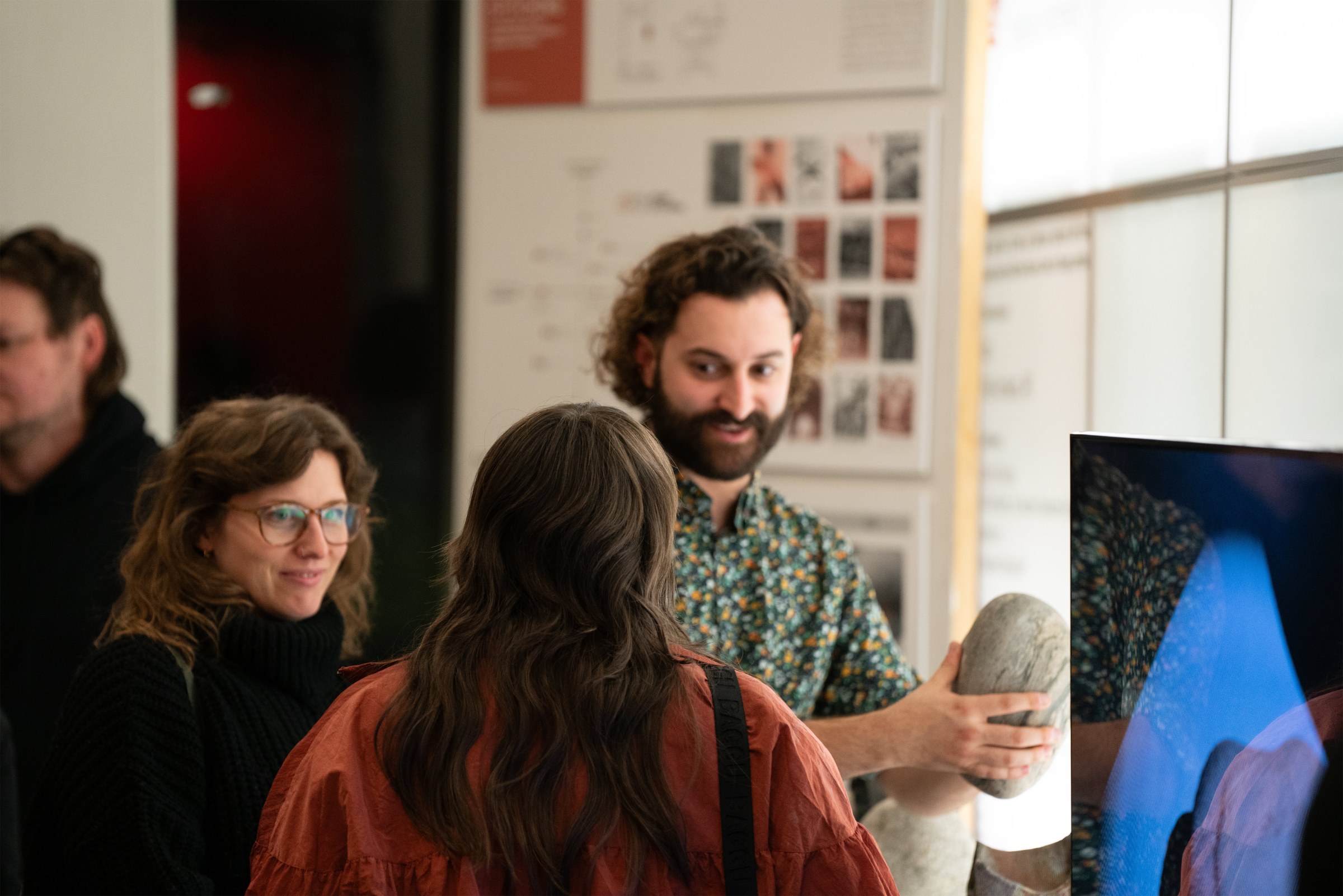 Image of an student and professor talking in an open house 