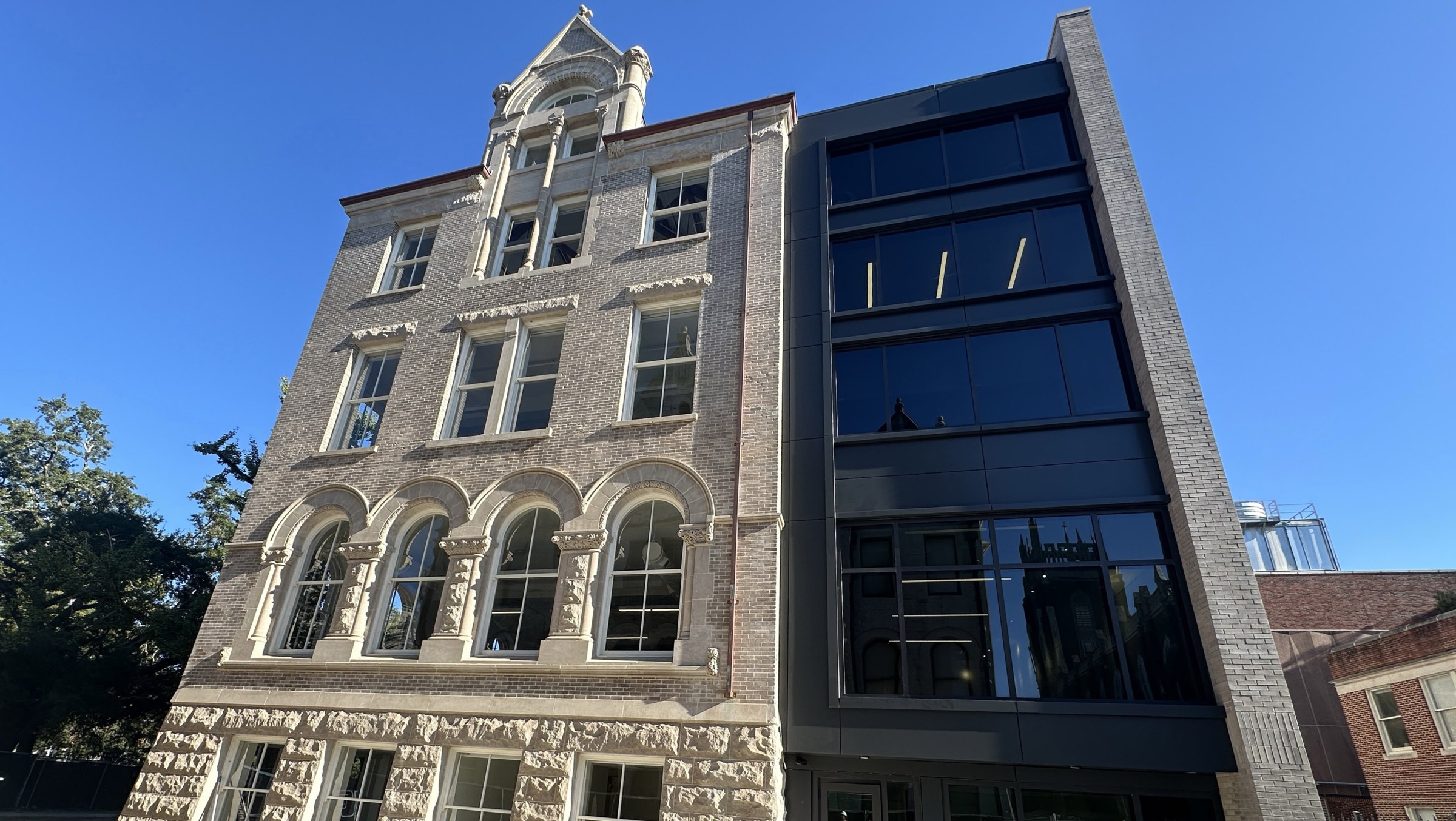 View looking up at north facade of Richardson Memorial Hall's renovation with addition on the right and original historic building on the left.