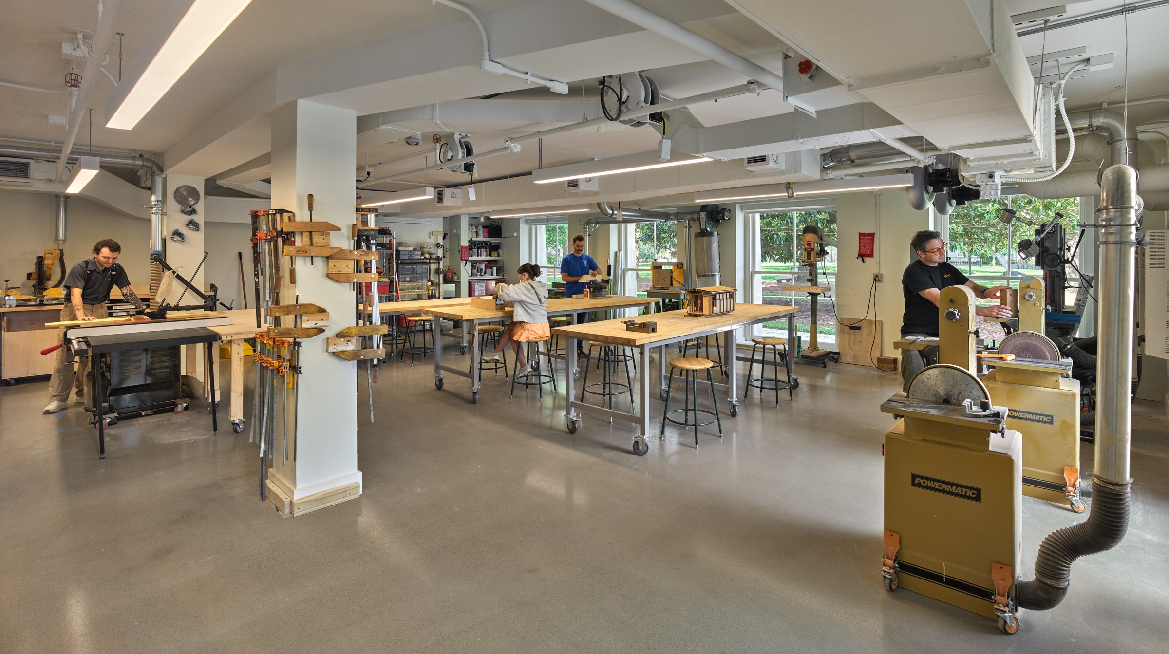 angled view of students and faculty working in the woodshop.