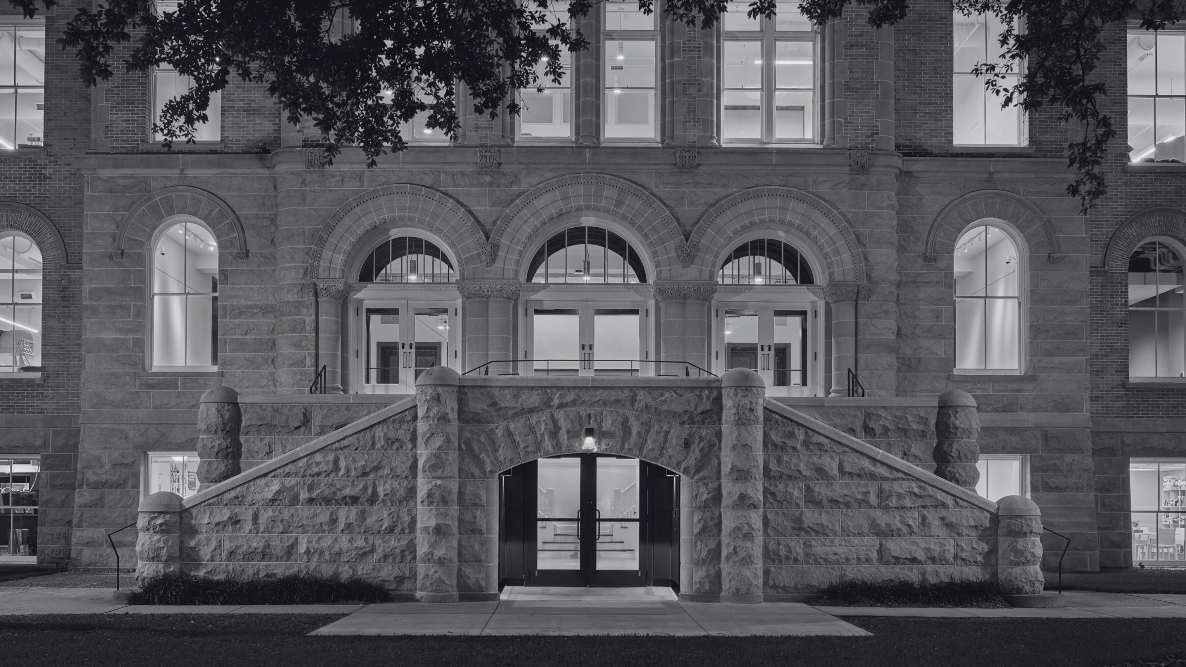 Exterior view of front facade of Richardson Memorial Hall, slightly close up to only see the first two floors and the main entrance in the middle.
