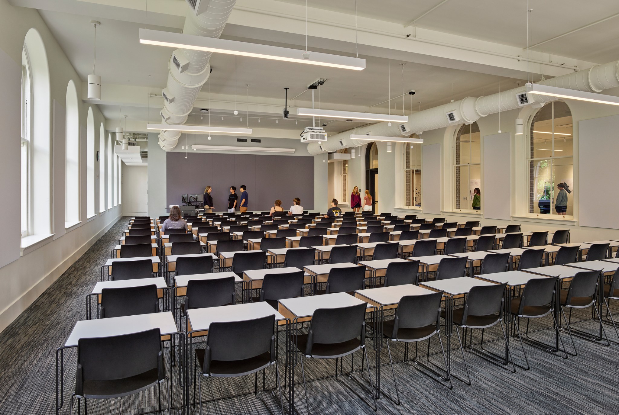 Inside corner view of Thomson Hall, a large lecture hall with movable desks and chairs.