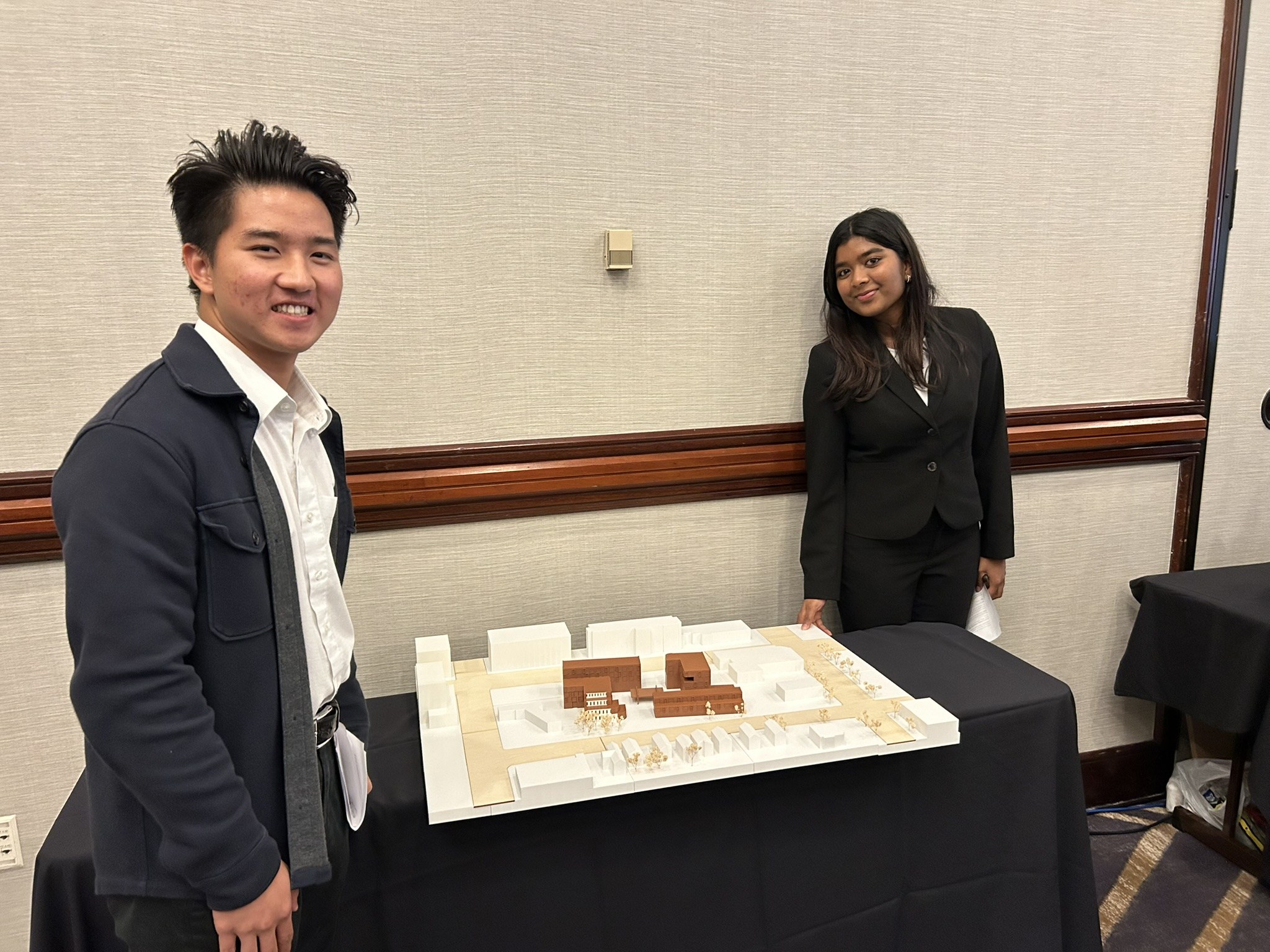 Diya and Dang, Tulane architecture students, pose with the 3-D model of their project