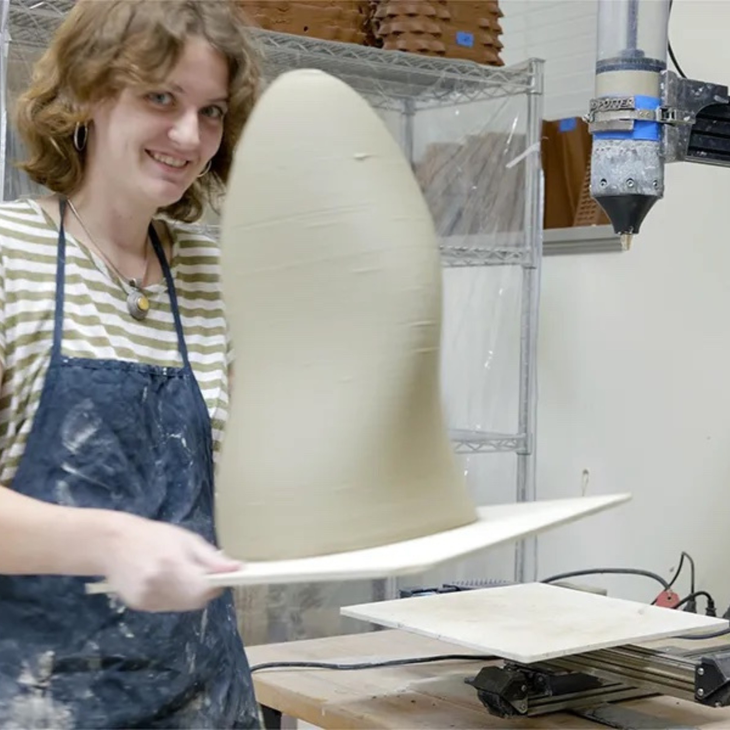 Square image of a student at work in the TUSABE Clay Fabrication Lab