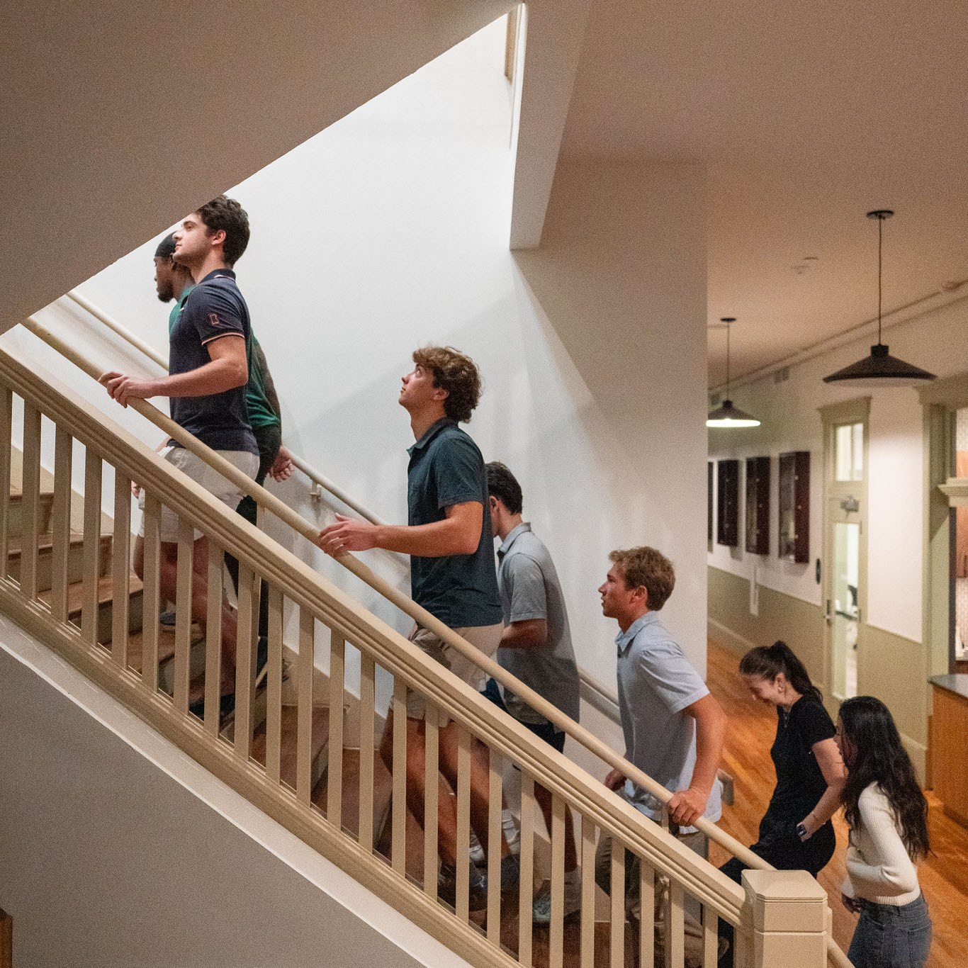 Side view of students walking up a staircase while on a real estate development field trip.