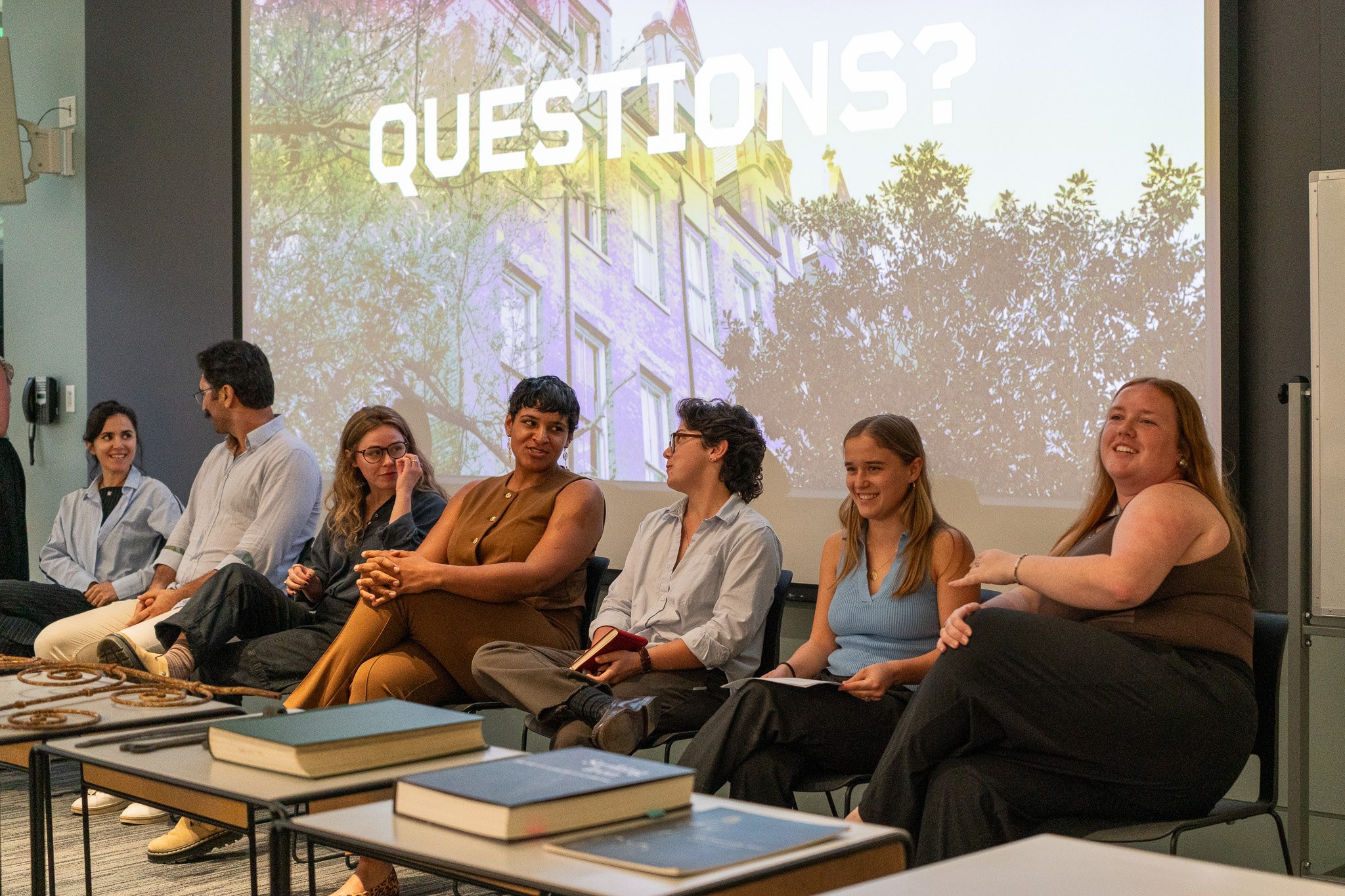 Students sit in front of a presentation answering questions