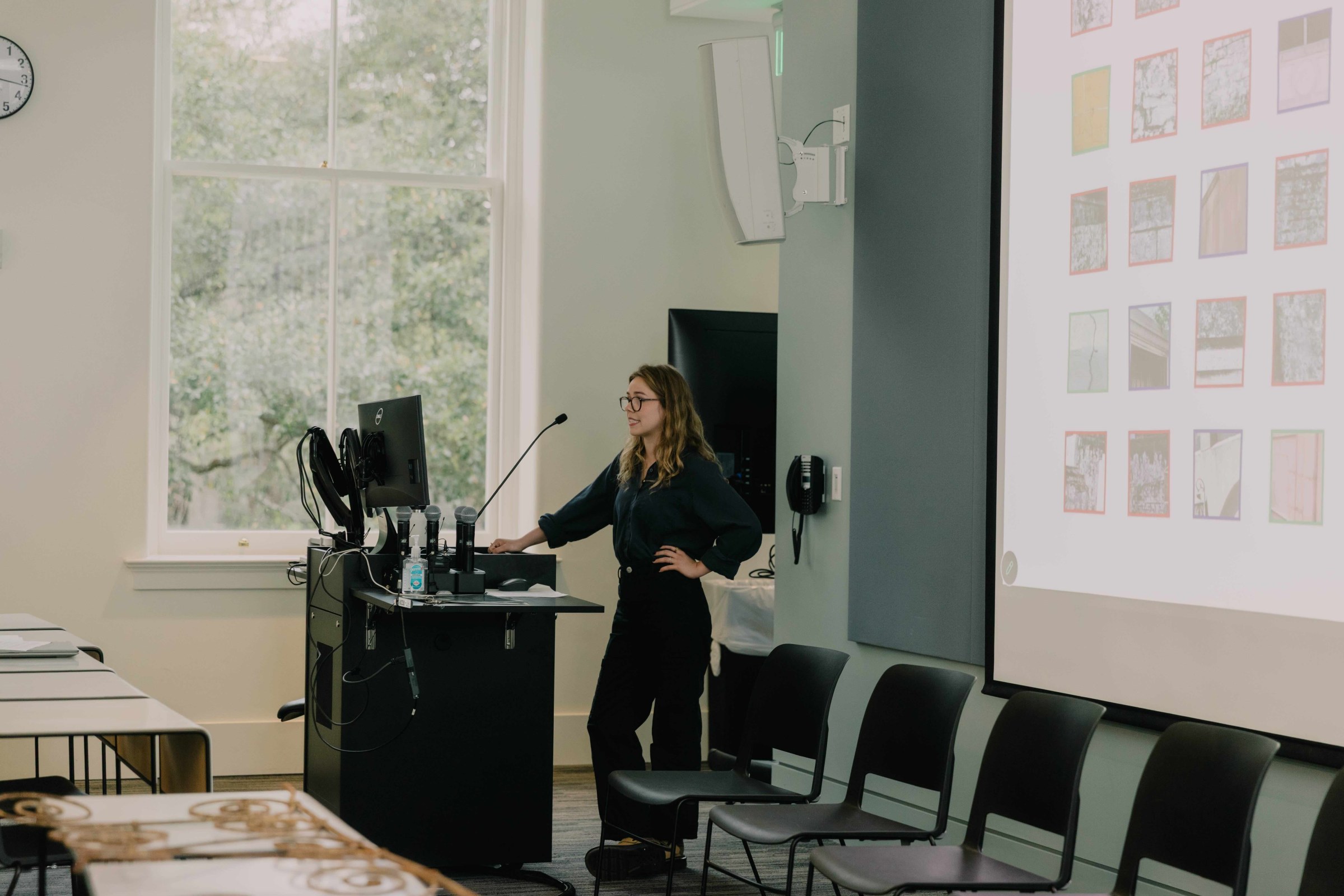 student presents in front of a slideshow