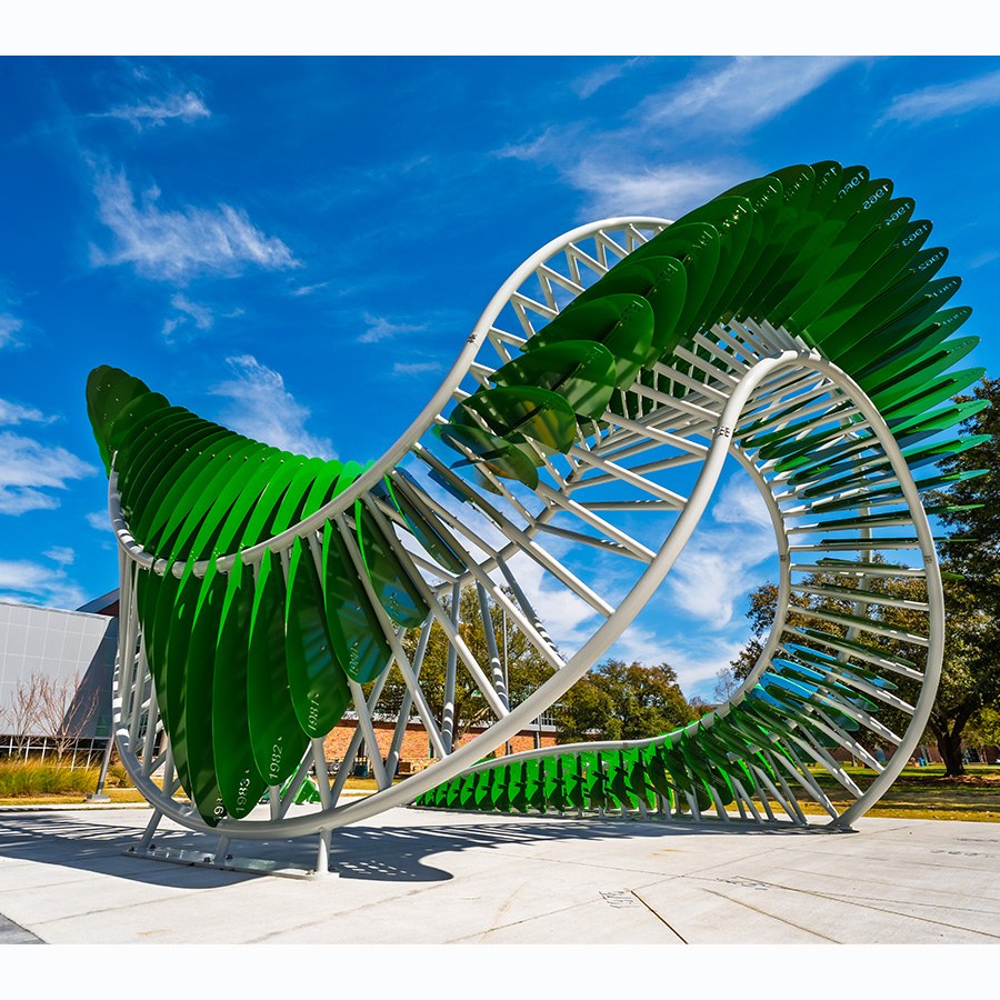 Side shot of the green curvy monument AION designed by Cordula Roser Gray